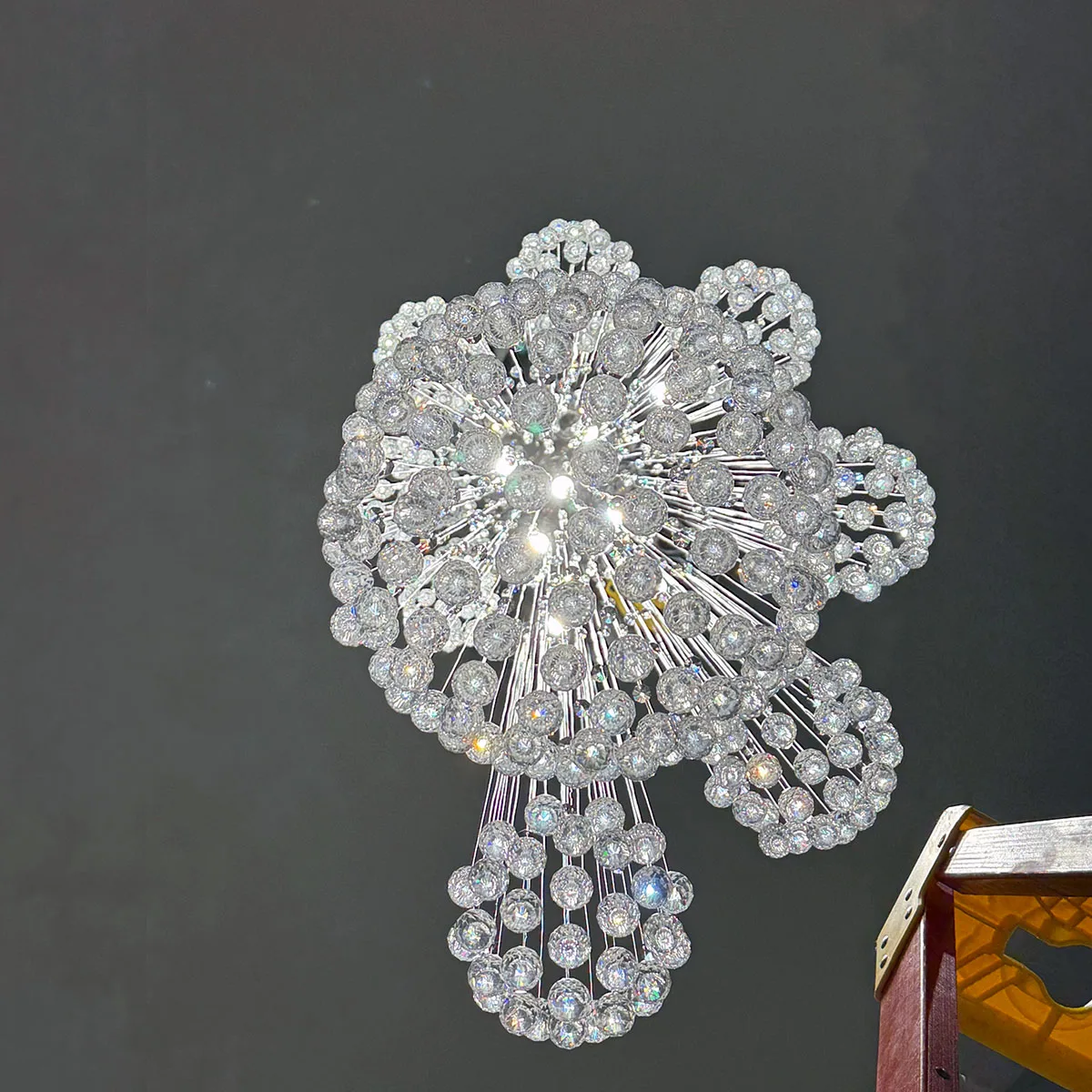 Crystal chandelier installation in a Sacramento home ceiling