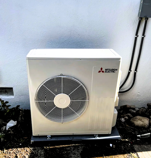 Technician performing heat pump installation in Sacramento home